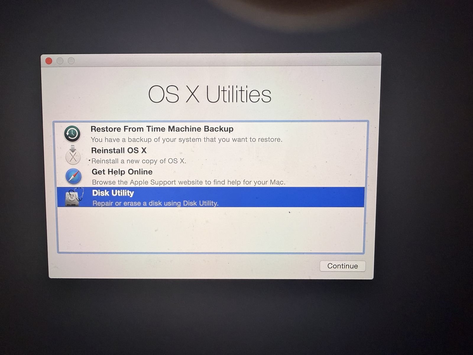 The macOS Utilities menu with Disk Utility selected